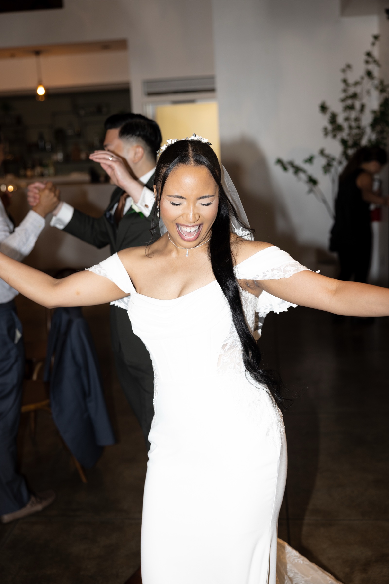 Kevin and Rachel with family portrait at the sweetheart table at The Colony House