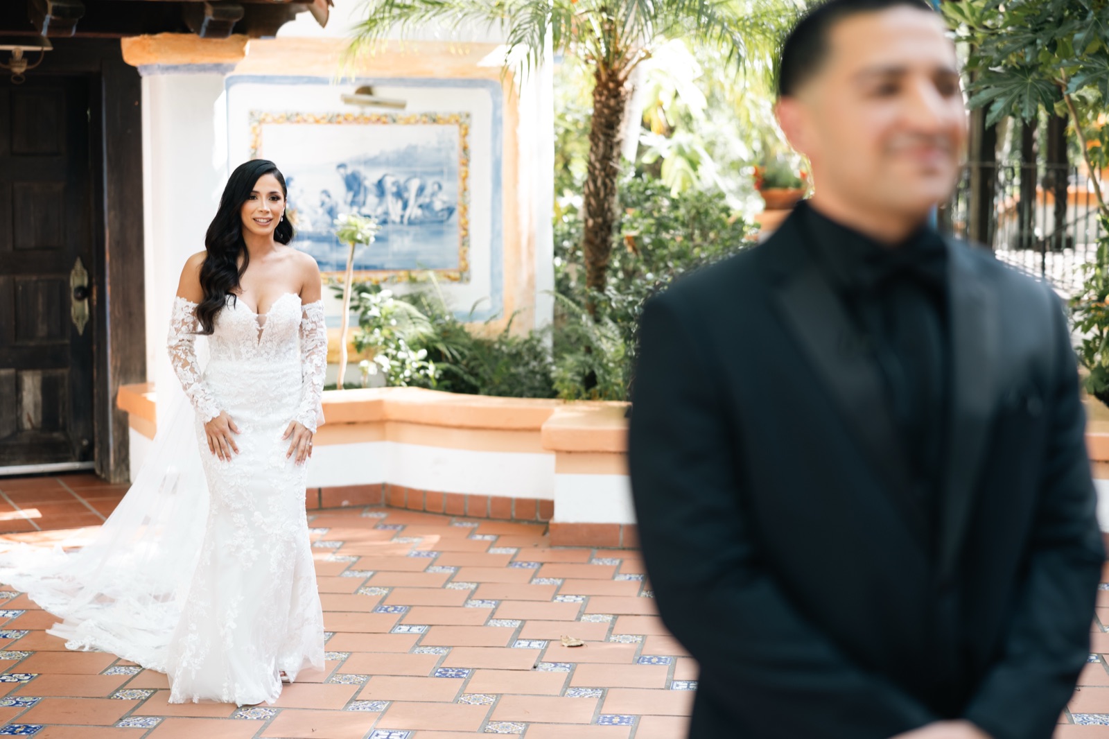 First look at Rancho Las Lomas, bride approaching groom on tile courtyard