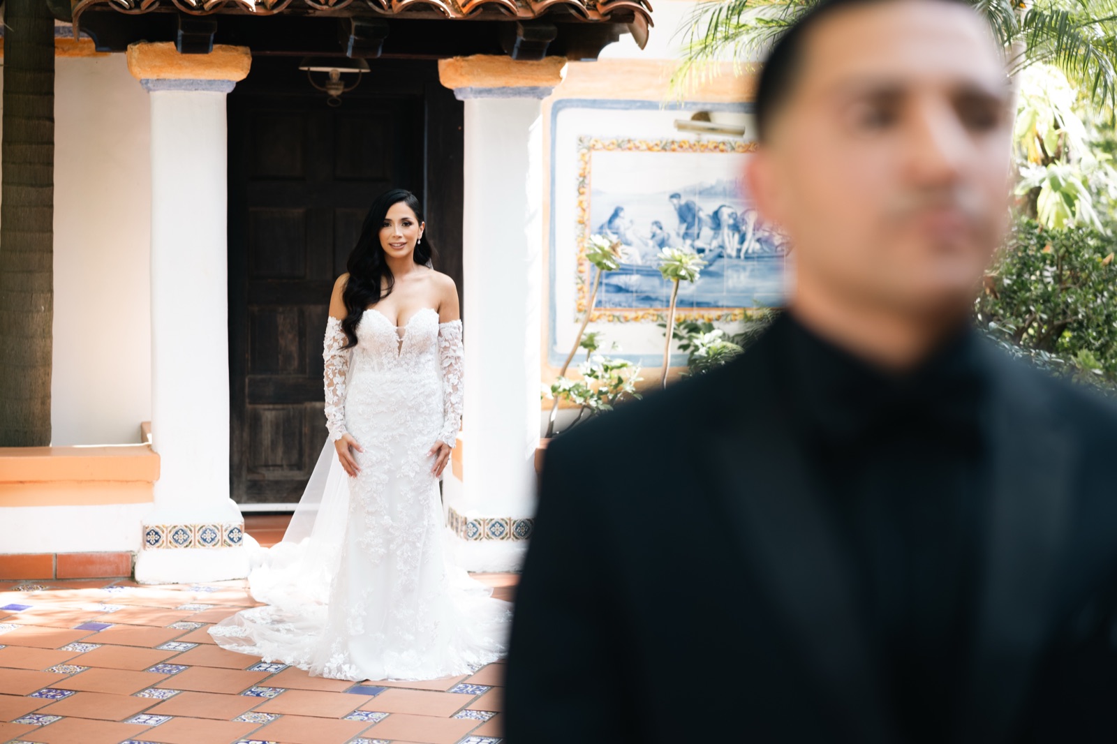 Mikey and Michelle first look, groom with bride in foreground at Rancho Las Lomas