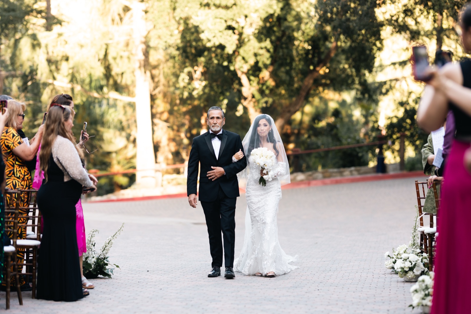 Bride walking down the aisle with her father at Rancho Las Lomas ceremony