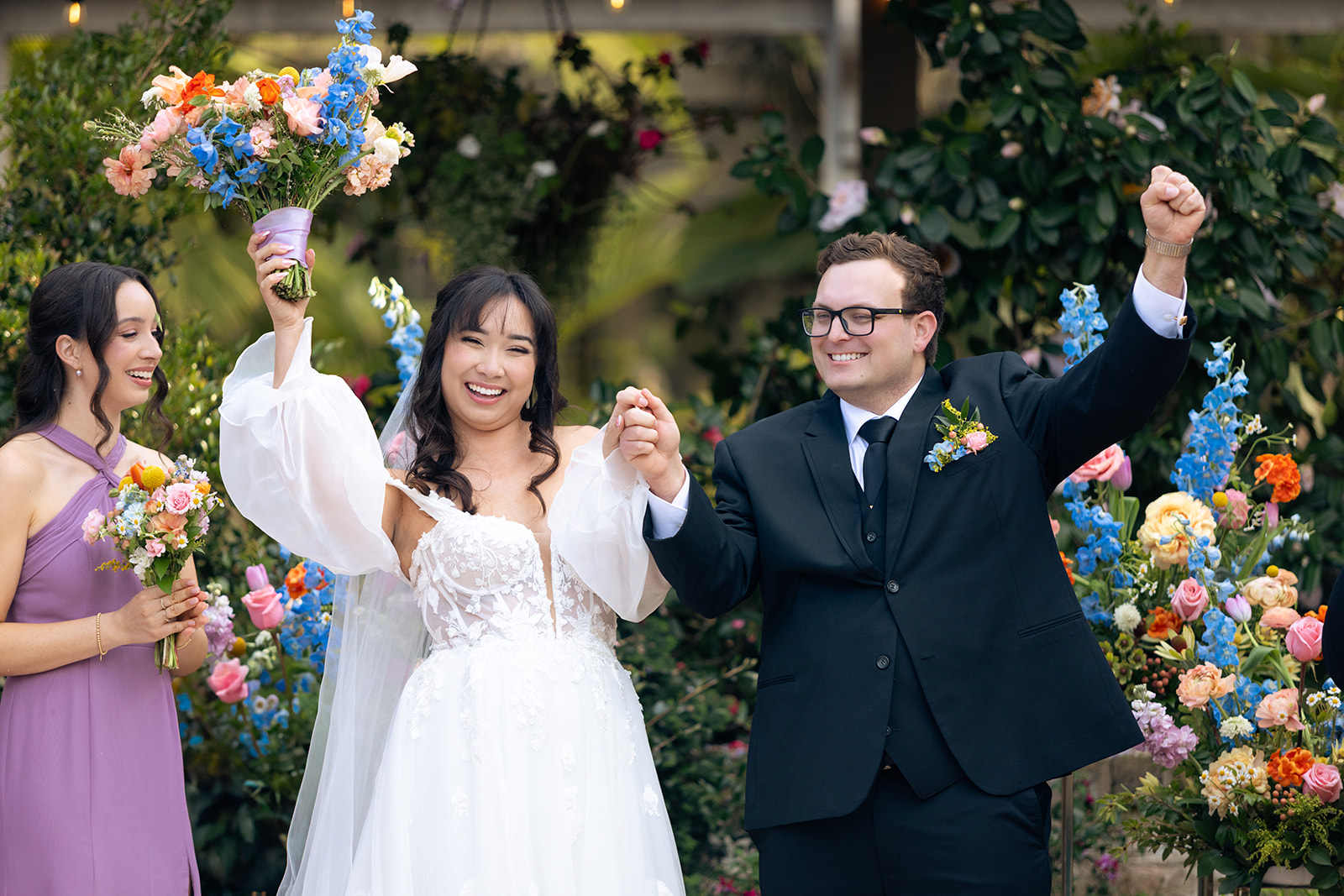 Janet and Ryan celebrating after being pronounced married at Sherman Library and Gardens