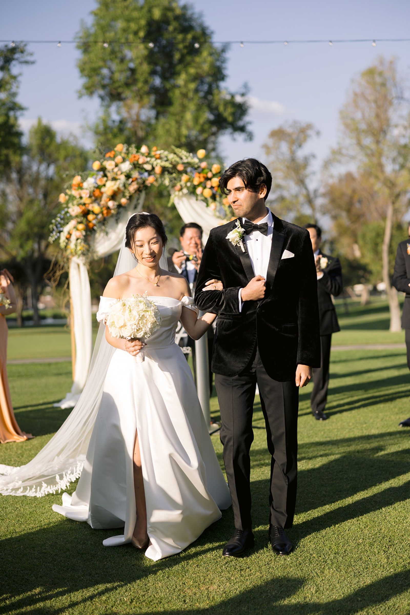 Newlyweds walking back up the aisle at South Hills