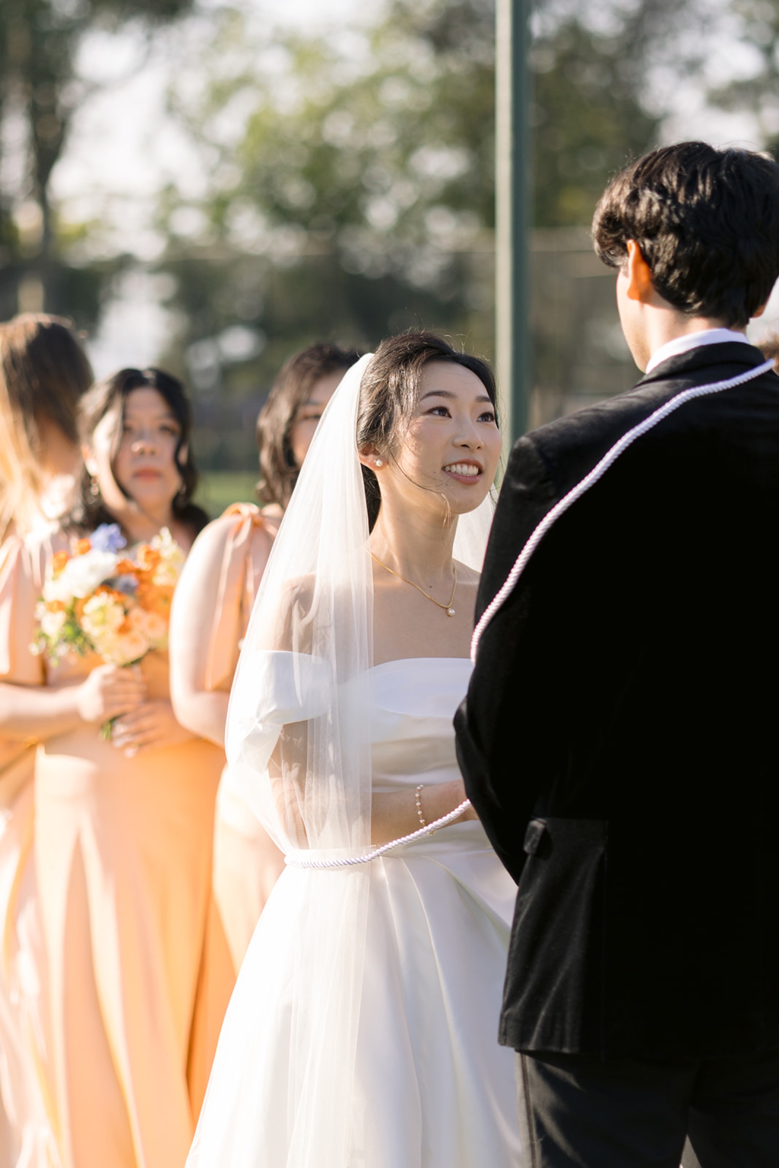 Bride smiling at groom during ceremony