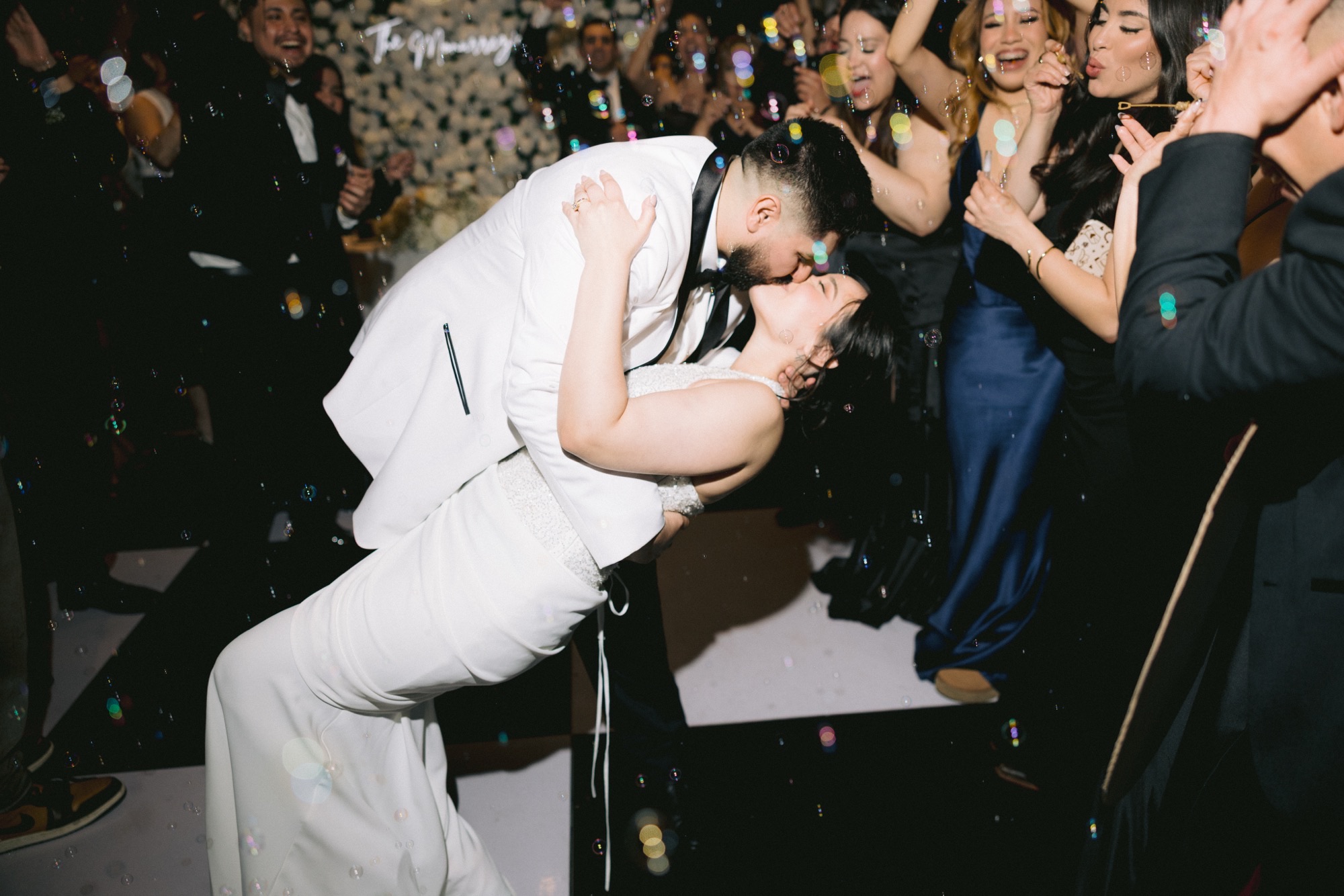 Couple sharing a kiss on the dance floor at their Southern California wedding